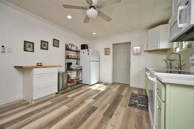 a kitchen with a refrigerator and a sink