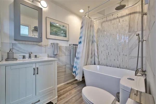 a bathroom with a sink toilet and shower