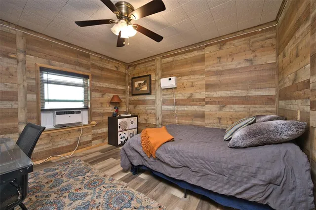 a bedroom with bed and a chandelier