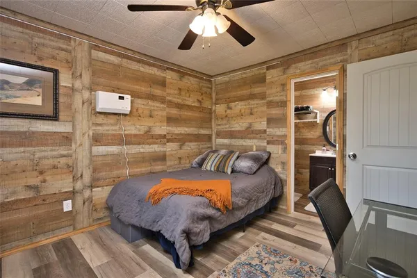 a bedroom with a bed and a chandelier