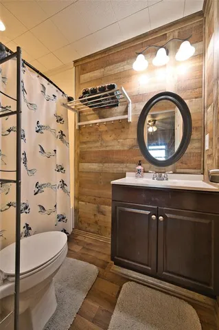 a bathroom with a sink a toilet and a shower curtain