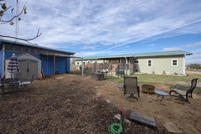 a view of a house with backyard and a sitting area