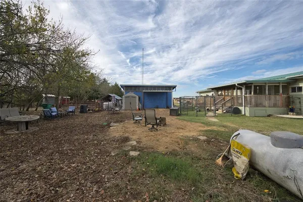 a view of a house with backyard and sitting area
