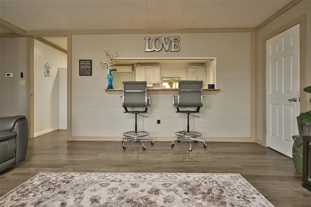 a view of a room with wooden floor and glass door