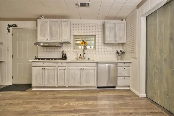 a kitchen with white cabinets and white appliances