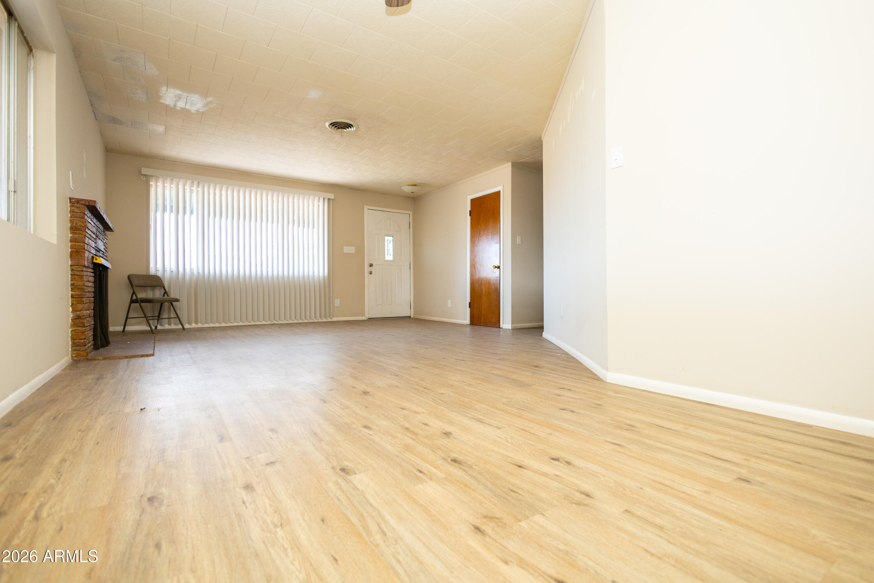 1626 11th Street Douglas, AZ 85607 - Photo 14 of 30 a view of empty room with wooden floor and fan