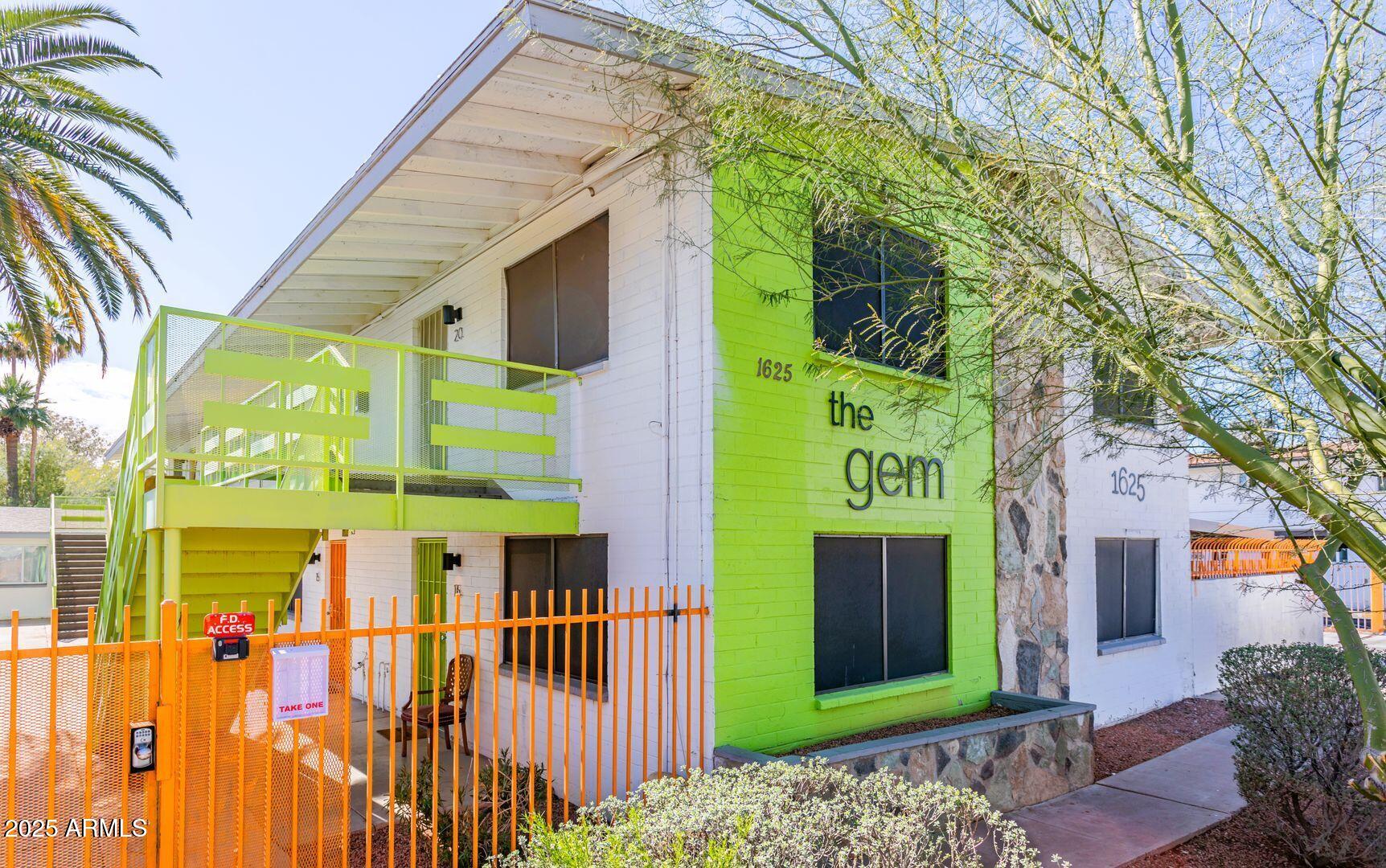 1625 West Missouri Avenue, Unit 12 Phoenix, AZ 85015 - Photo 11 of 12 a front view of a building with glass door and windows