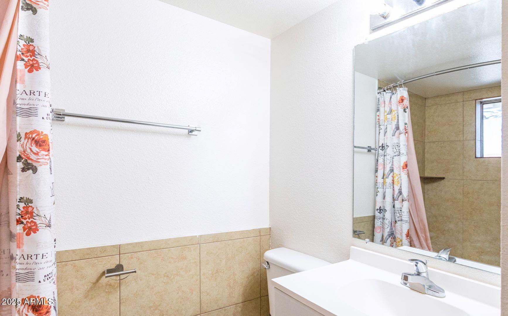 1625 West Missouri Avenue, Unit 12 Phoenix, AZ 85015 - Photo 7 of 12 a bathroom with a sink and a mirror
