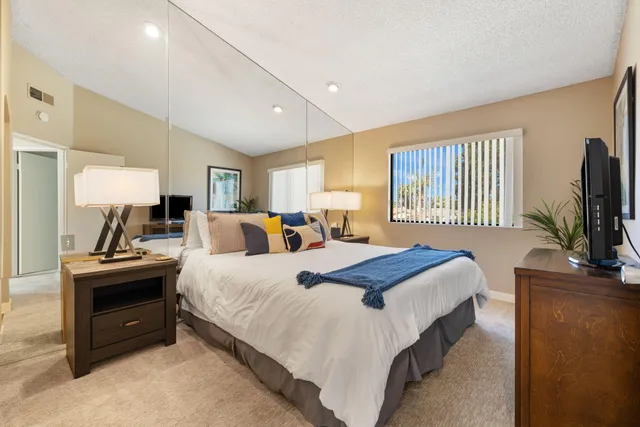 a kitchen with stainless steel appliances kitchen island granite countertop a refrigerator and microwave