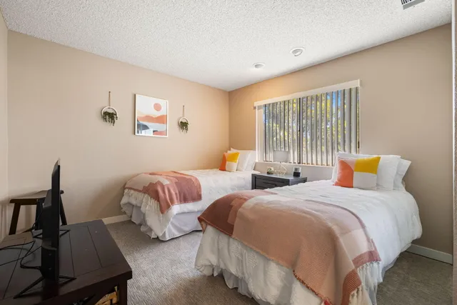 a living room with fireplace furniture and a flat screen tv