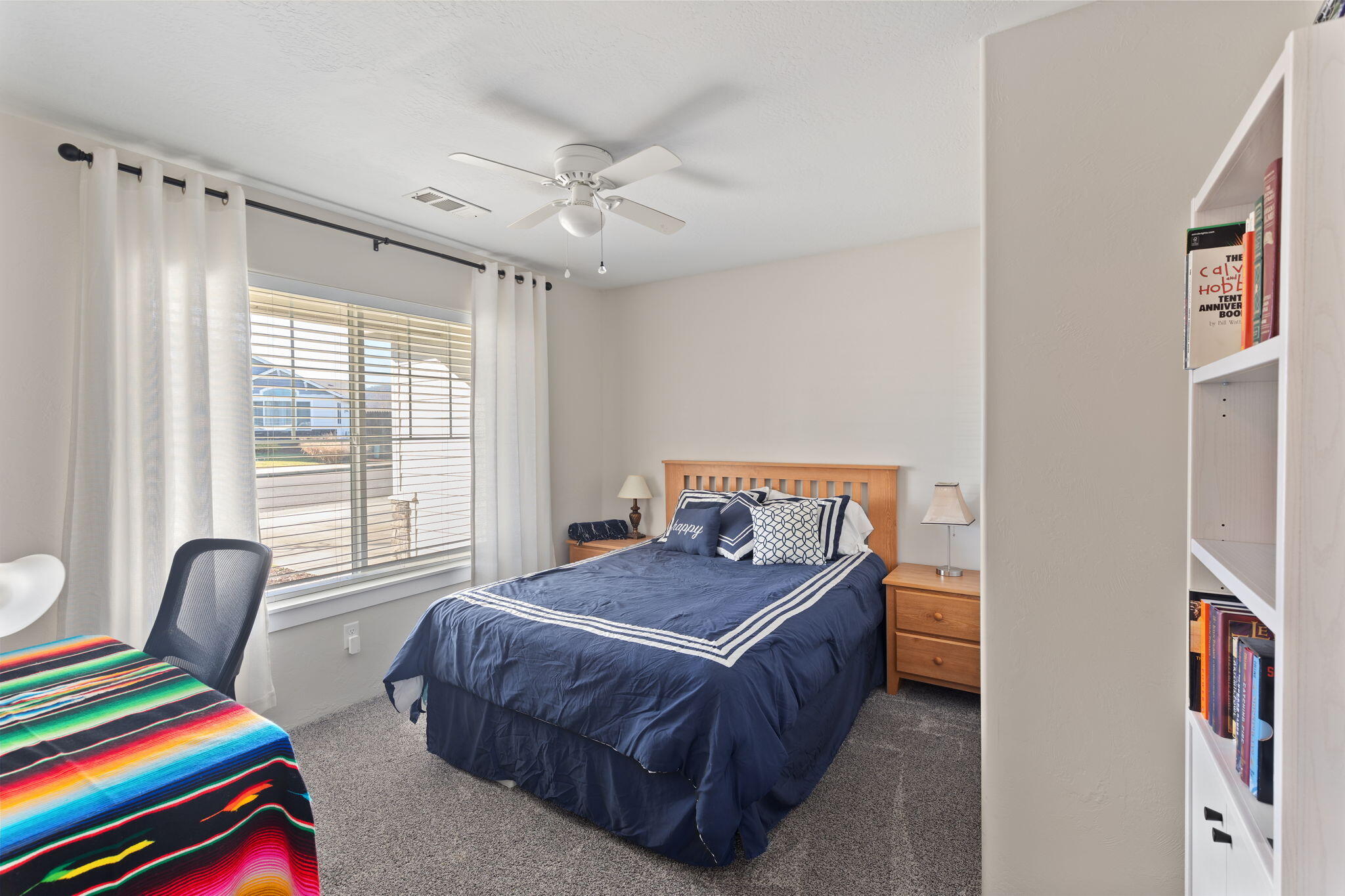 110 Linton Way Eagle Point, OR 97524 - Photo 19 of 41 a bedroom with a bed and a chandelier