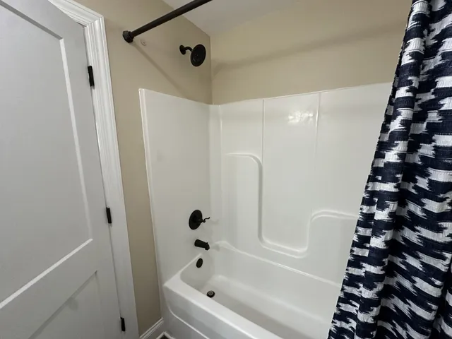 a bathroom with a bathtub and shower