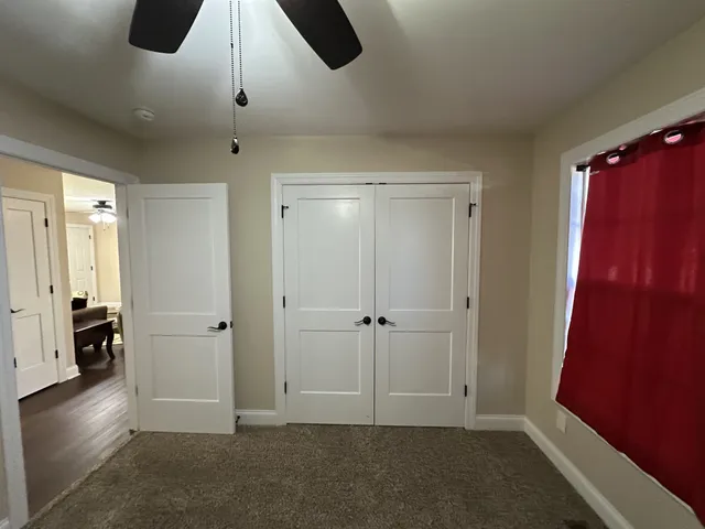 a view of walk in closet with empty racks