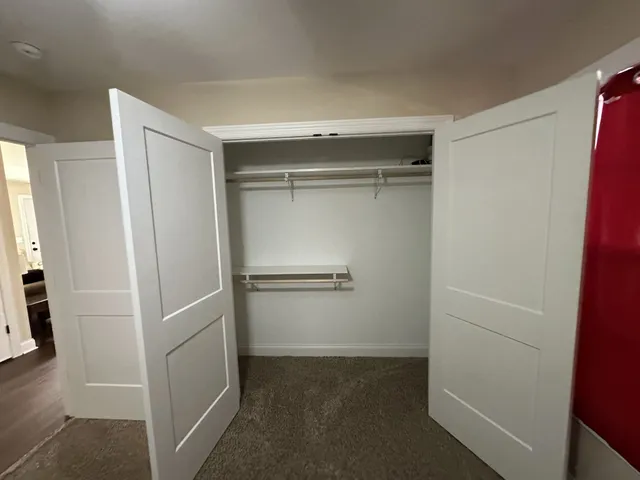 an empty room with windows and closet