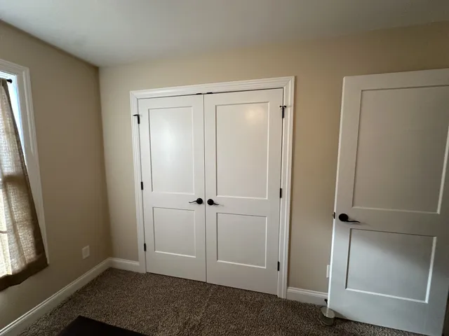 a room with wooden floor and white walls