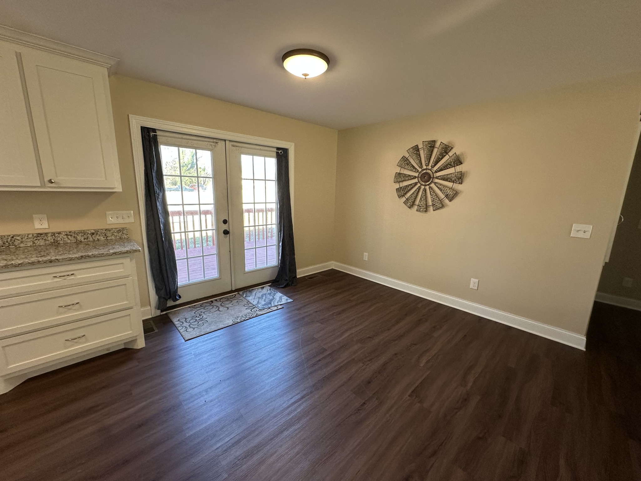 104 Lincoln Street Ethridge, TN 38456 - Photo 21 of 23 an empty room with wooden floor and windows