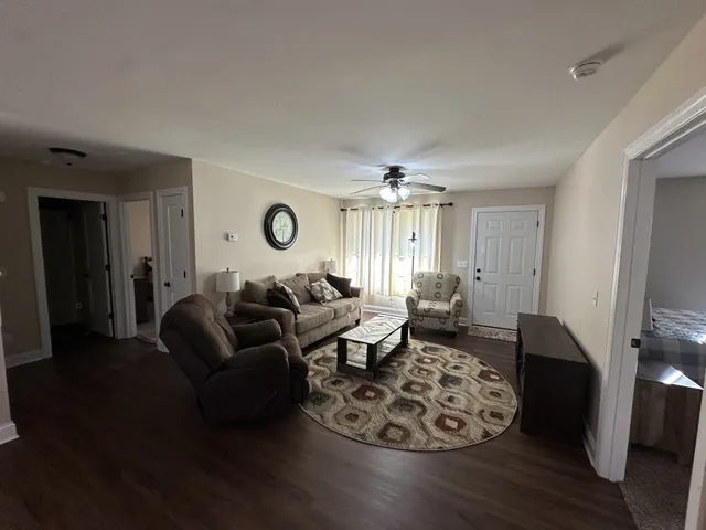 a living room with furniture window and wooden floor