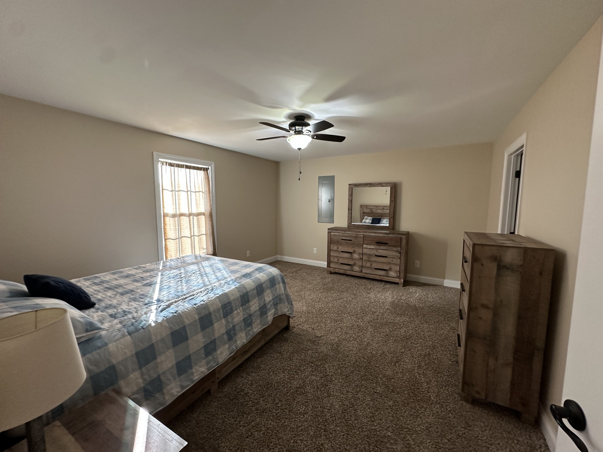 104 Lincoln Street Ethridge, TN 38456 - Photo 8 of 23 a spacious bedroom with a bed and a chandelier