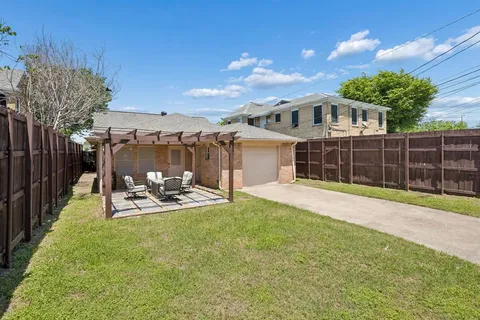 a view of a house with backyard porch and sitting area