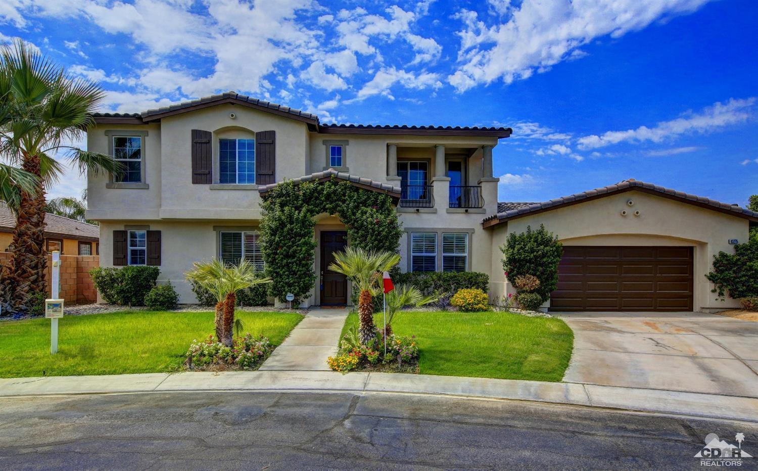 83275 Lightning Road Indio, CA 92203 - Photo 2 of 28 a front view of a house with a yard and garage