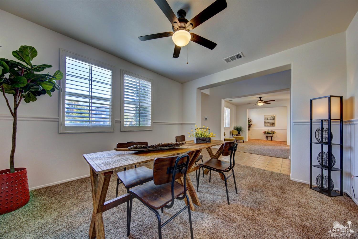 83275 Lightning Road Indio, CA 92203 - Photo 11 of 28 a dining room with furniture and window