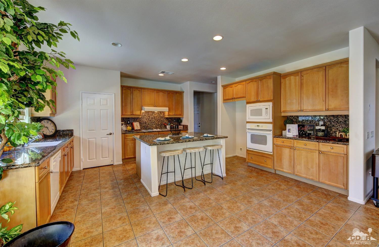 83275 Lightning Road Indio, CA 92203 - Photo 12 of 28 a kitchen with a refrigerator and a stove