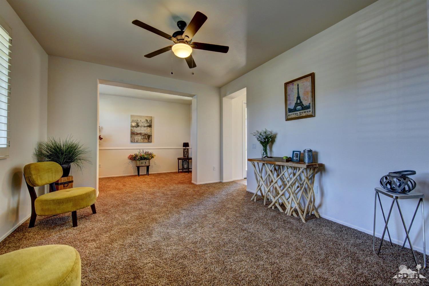 83275 Lightning Road Indio, CA 92203 - Photo 13 of 28 a living room with furniture and a chandelier