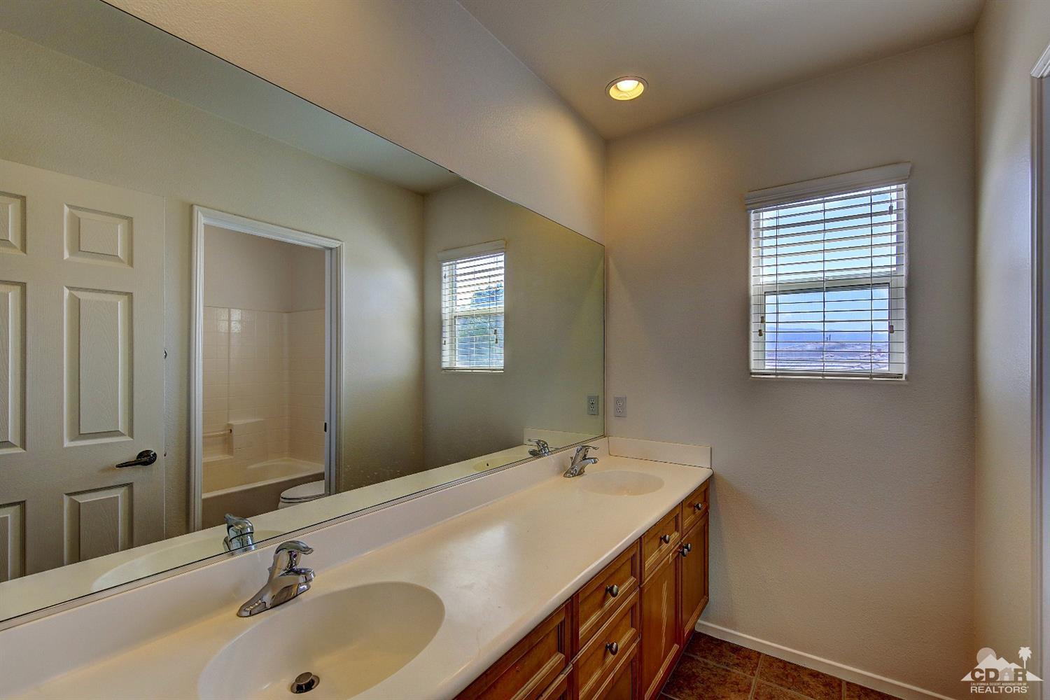 83275 Lightning Road Indio, CA 92203 - Photo 18 of 28 a bathroom with a sink and a mirror