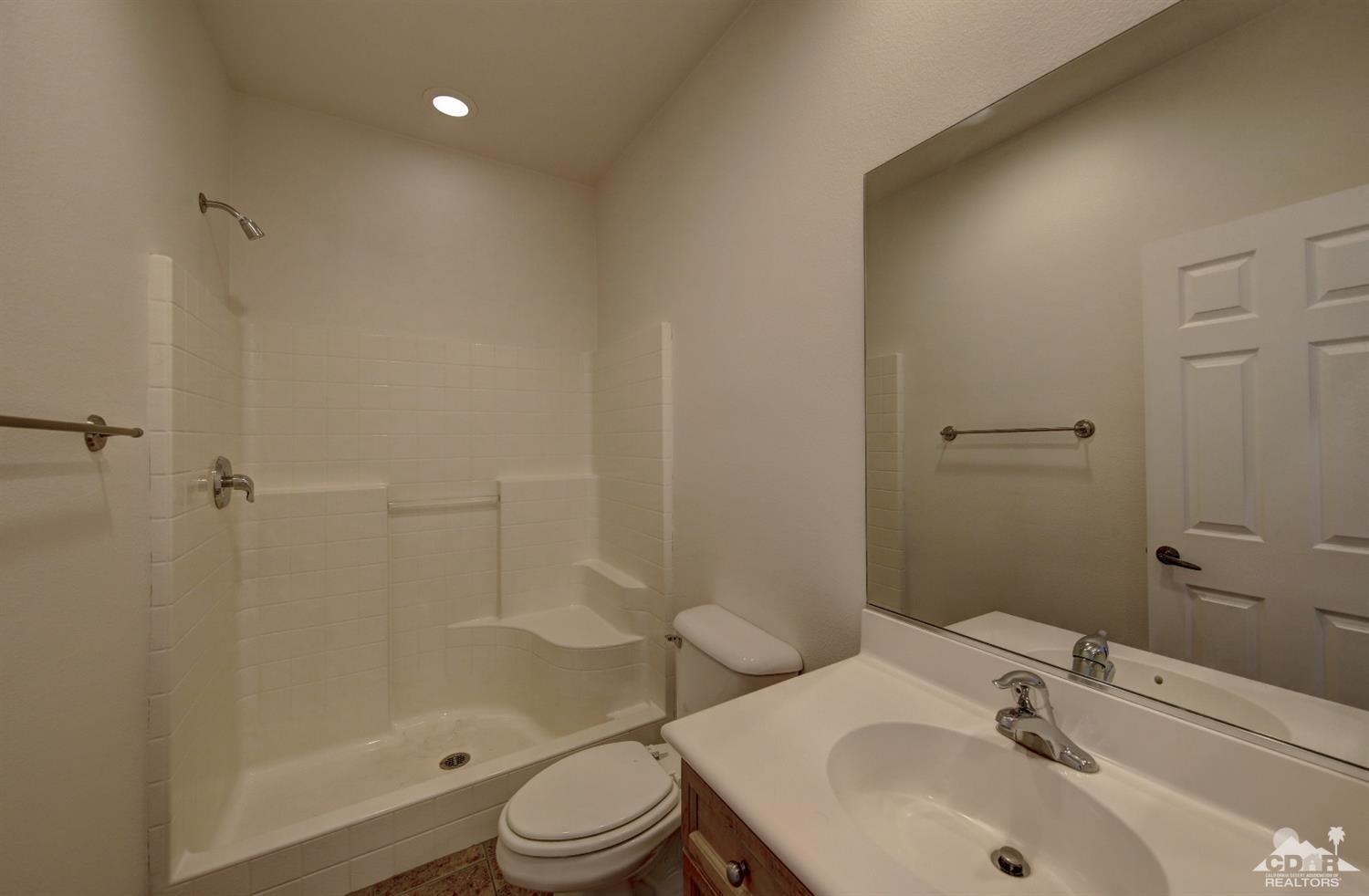 83275 Lightning Road Indio, CA 92203 - Photo 19 of 28 a bathroom with a sink toilet and shower