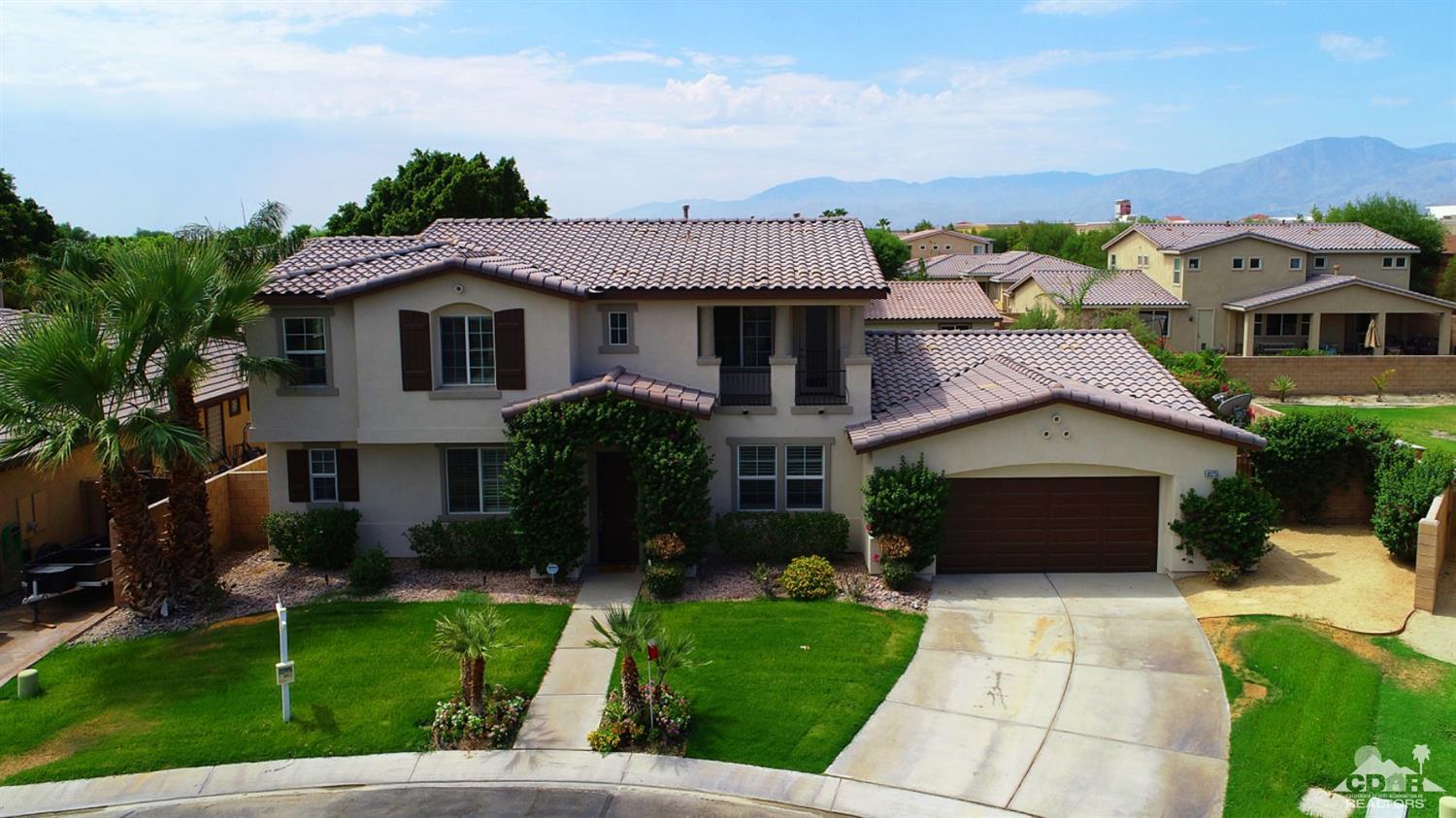 83275 Lightning Road Indio, CA 92203 - Photo 3 of 28 a front view of a house with a garden