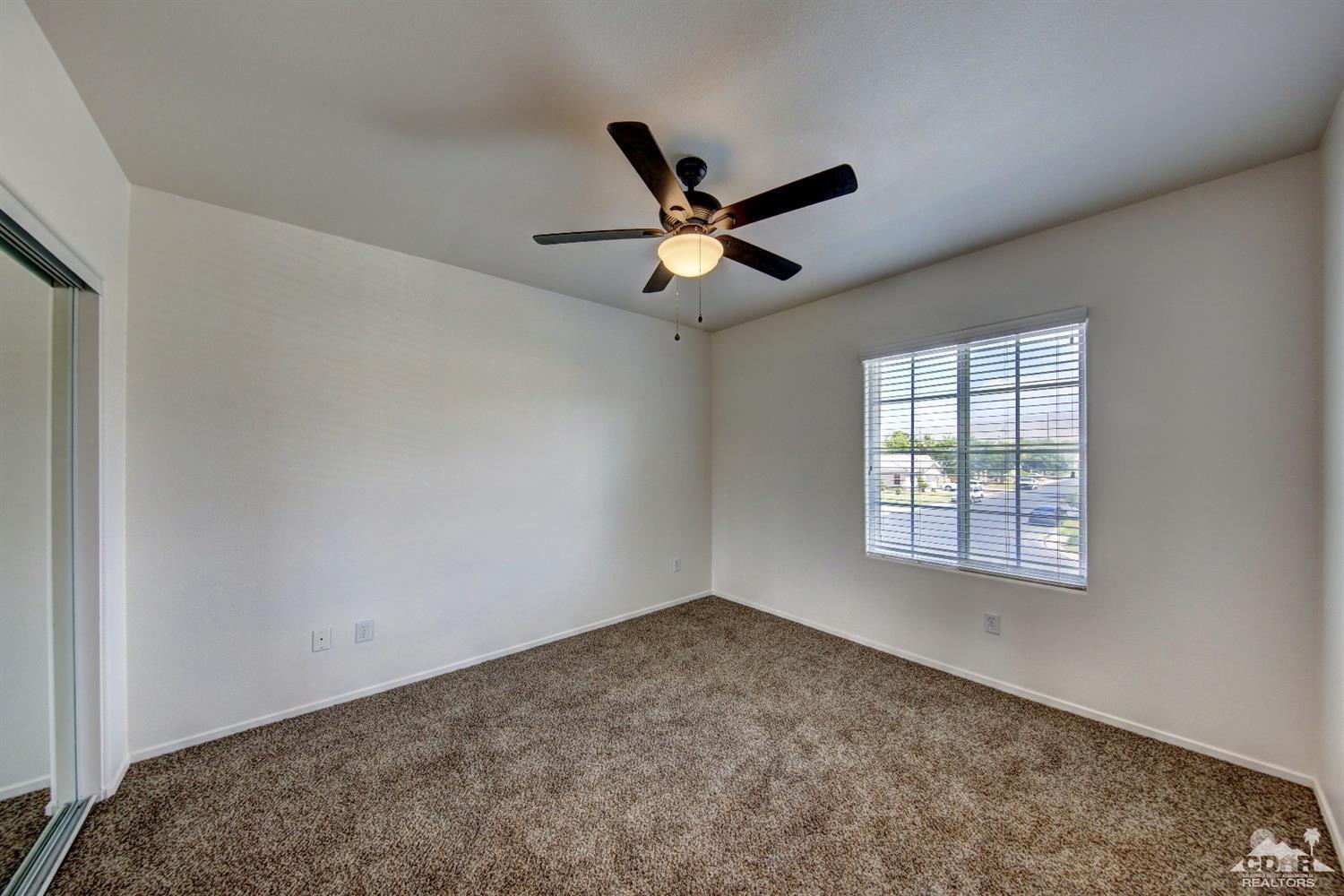 83275 Lightning Road Indio, CA 92203 - Photo 22 of 28 a view of a room with a window and a ceiling fan