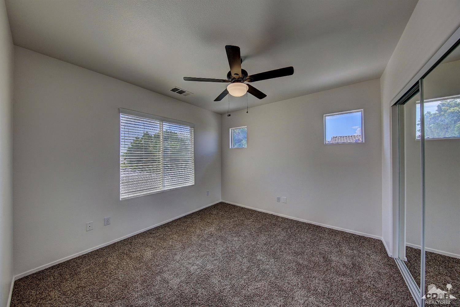 83275 Lightning Road Indio, CA 92203 - Photo 23 of 28 a view of room with a ceiling fan and window
