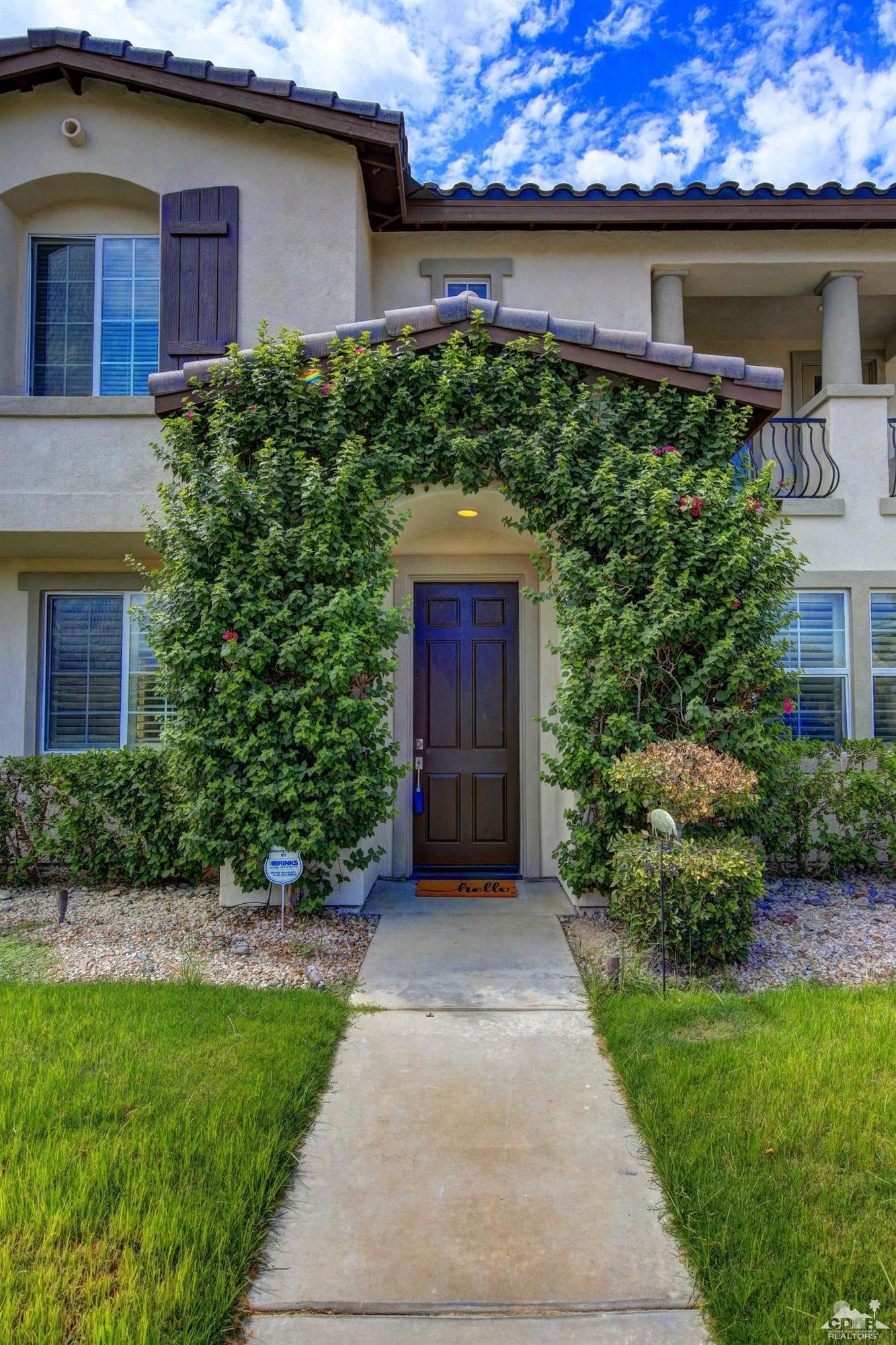 83275 Lightning Road Indio, CA 92203 - Photo 4 of 28 a front view of a house with a garden
