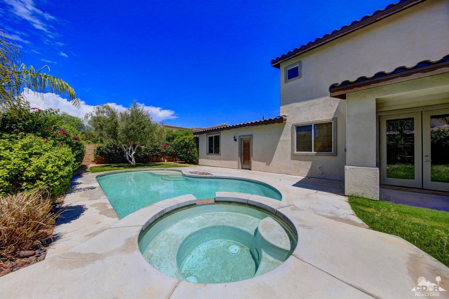83275 Lightning Road Indio, CA 92203 - Photo 5 of 28 a view of a house with a backyard patio and a garden