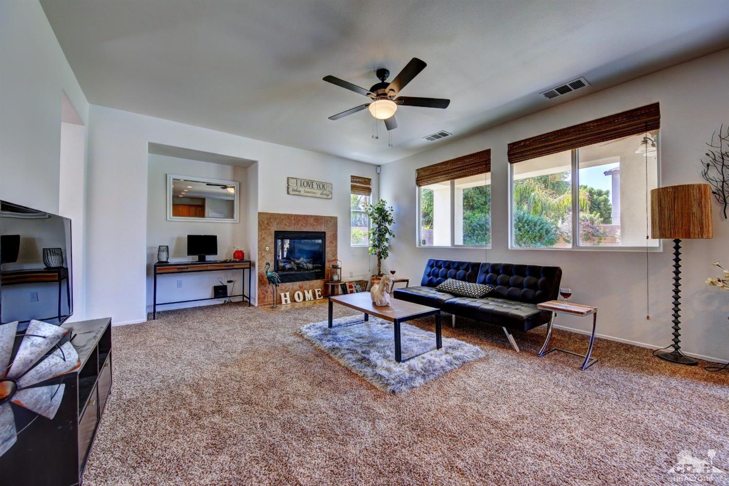 83275 Lightning Road Indio, CA 92203 - Photo 10 of 28 a living room with furniture a fireplace and a flat screen tv