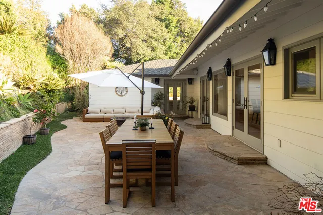 a view of a patio with table and chairs and potted plants