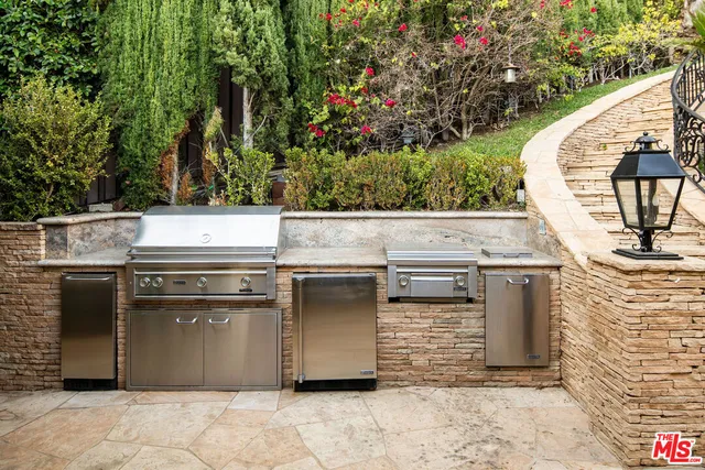 a stove top oven sitting inside of a kitchen