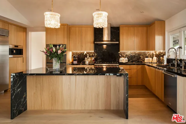 a kitchen with sink and refrigerator