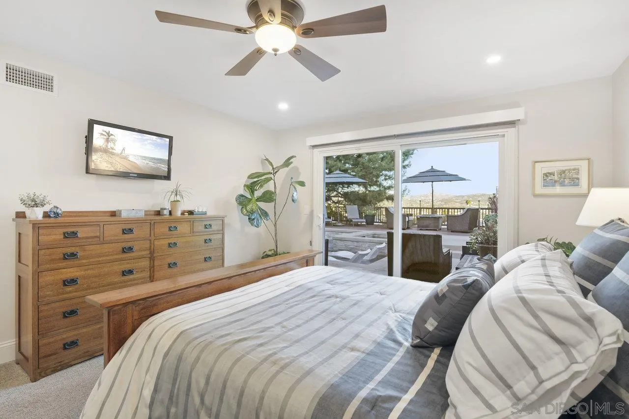 1353 Eastside Road El Cajon, CA 92020 - Photo 18 of 43 a bedroom with a bed and ceiling fan