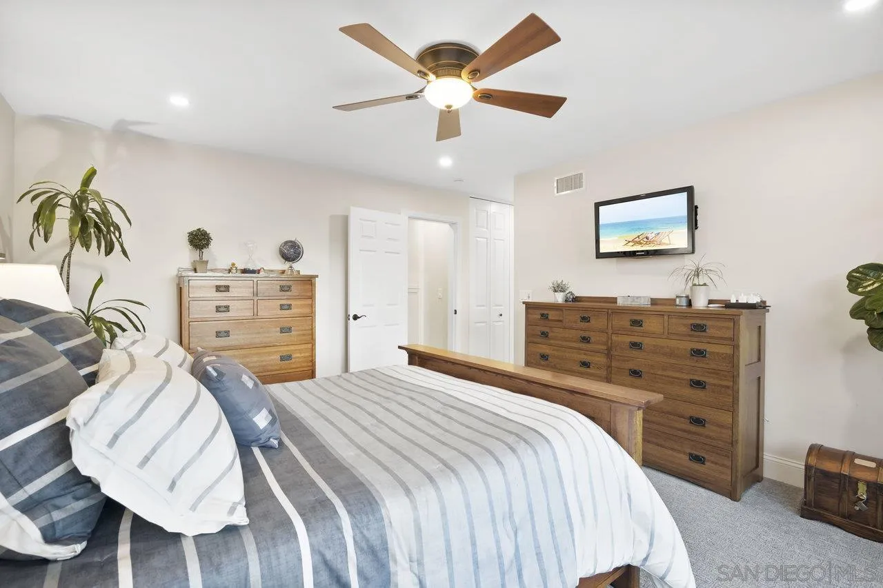 1353 Eastside Road El Cajon, CA 92020 - Photo 19 of 43 a bedroom with a bed and a chandelier