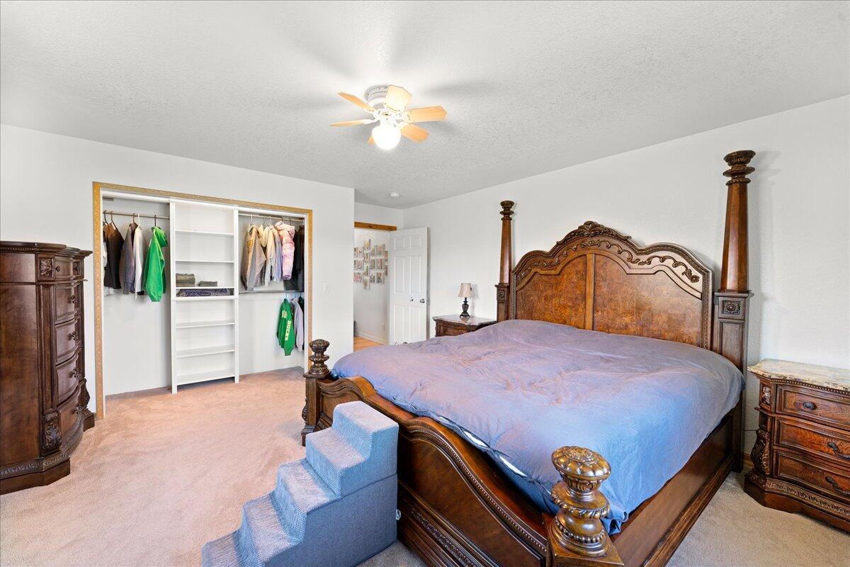 649 Pleasant Valley Road Merlin, OR 97532 - Photo 37 of 57 a bedroom with a bed and a chandelier
