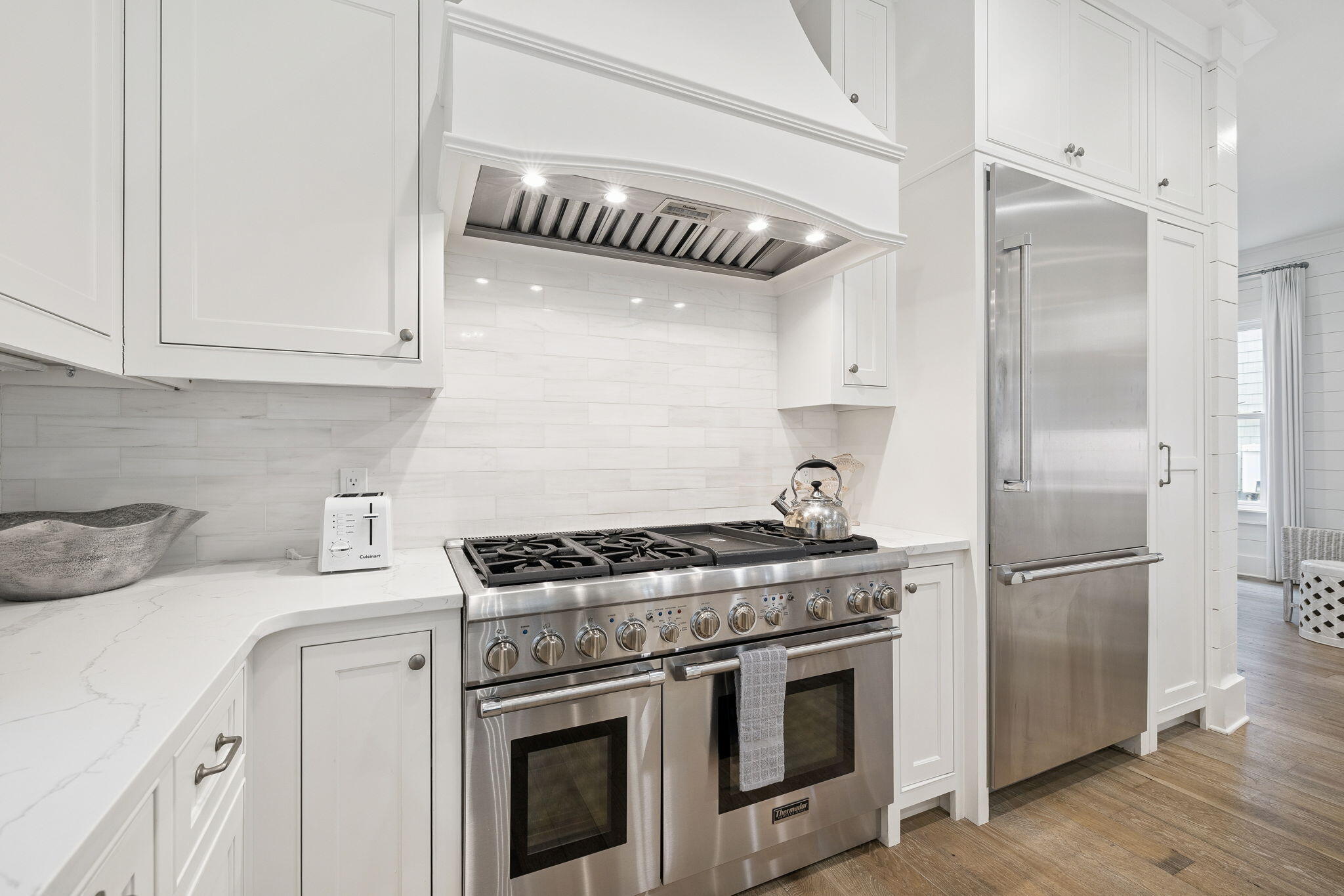 17 Compass Point Way Watersound, FL 32461 - Photo 23 of 73 a kitchen with stainless steel appliances granite countertop a stove a refrigerator and a white cabinets