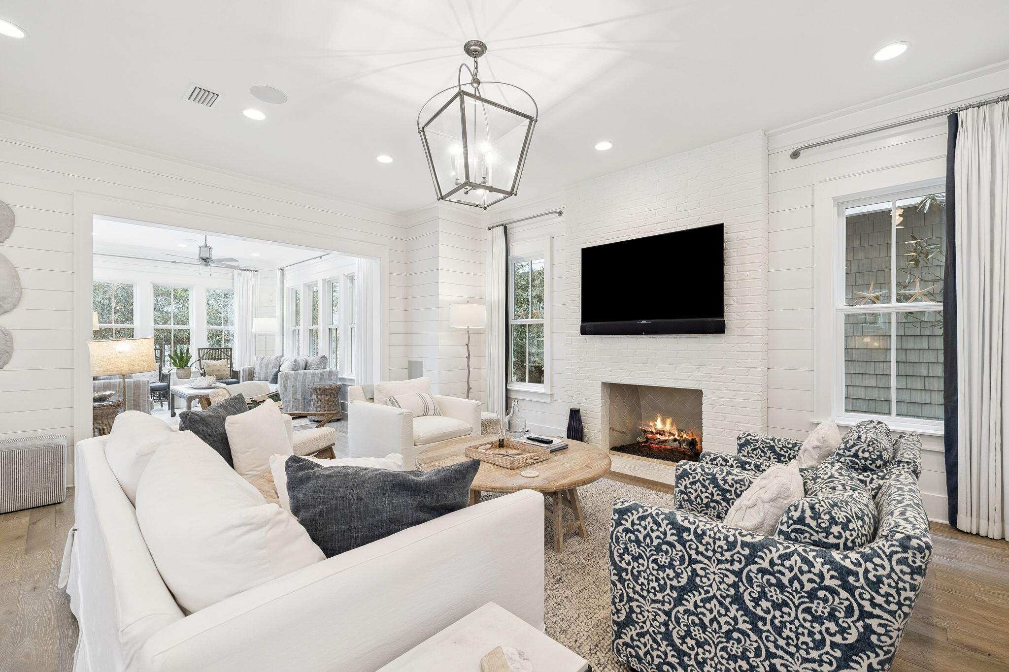 17 Compass Point Way Watersound, FL 32461 - Photo 26 of 73 a living room with furniture a fireplace a flat screen tv and a large window