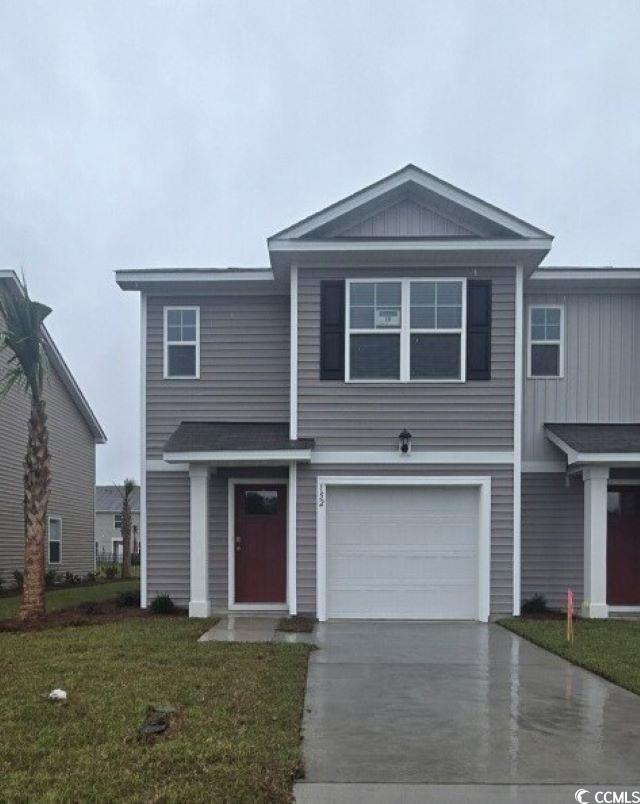 152 Bayou Loop, Unit LOT 18 Surfside Beach, SC 29575 - Photo 1 of 17 View of front facade featuring a front yard, driveway, board and batten siding, and a garage