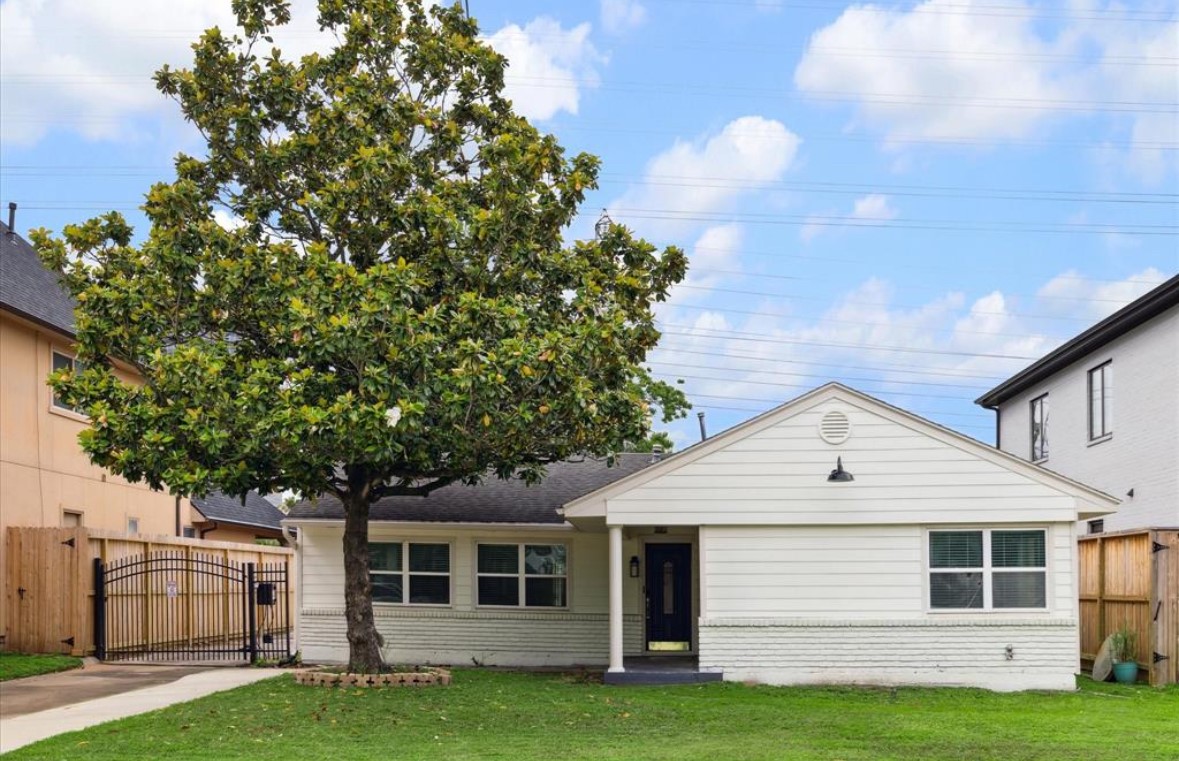 3818 Childress Street Houston, TX 77005 - Photo 1 of 10 a front view of a house with a garden and trees