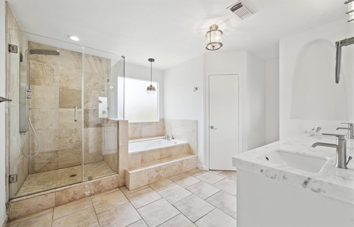 3818 Childress Street Houston, TX 77005 - Photo 6 of 10 a bathroom with a shower and a sink a mirror