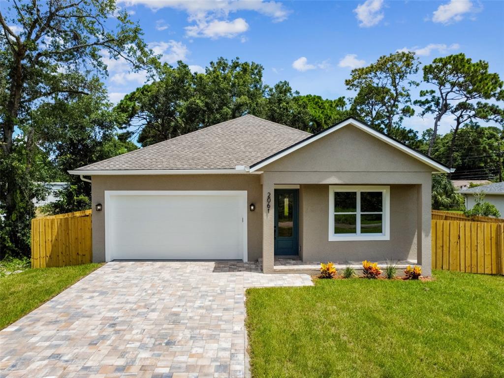 a front view of a house with a yard and garage