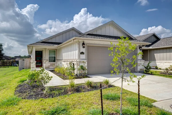 a front view of house with yard and outdoor seating