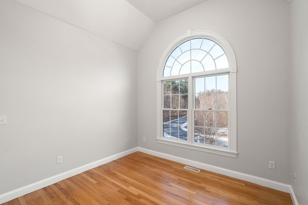 40 Sandy Ridge Road Sterling, MA 01564 - Photo 16 of 33 an empty room with wooden floor windows and entrance
