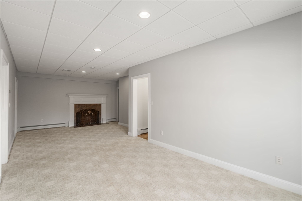 40 Sandy Ridge Road Sterling, MA 01564 - Photo 21 of 33 an empty room with fireplace and a window
